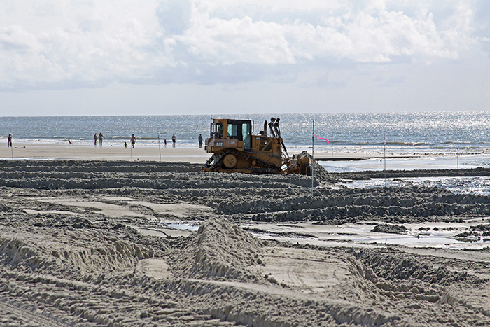 Bulldozer pushing sand