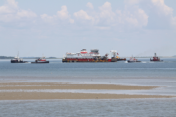 Dredge and tug boats entering Town Waters