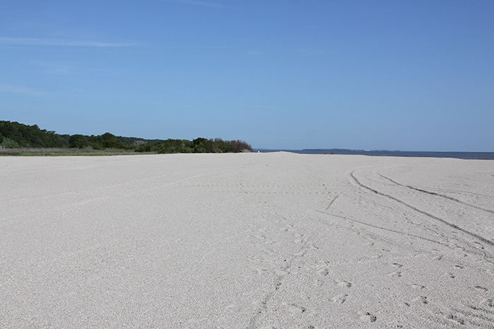 Temporary sand beach access ramp constructed over pipe