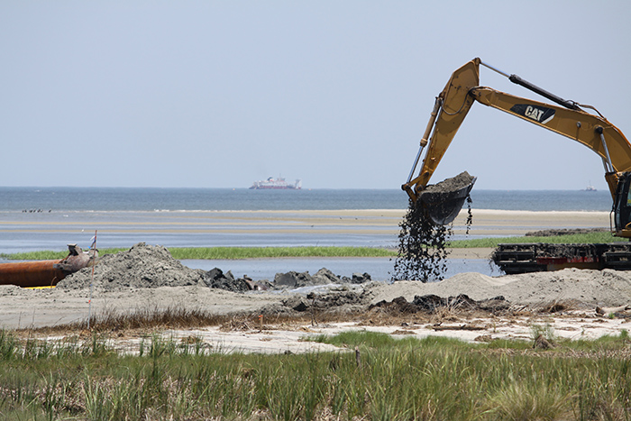 Temporary sand beach access ramp constructed over pipe