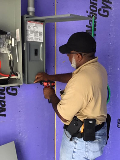 Man inspecting building electrical box