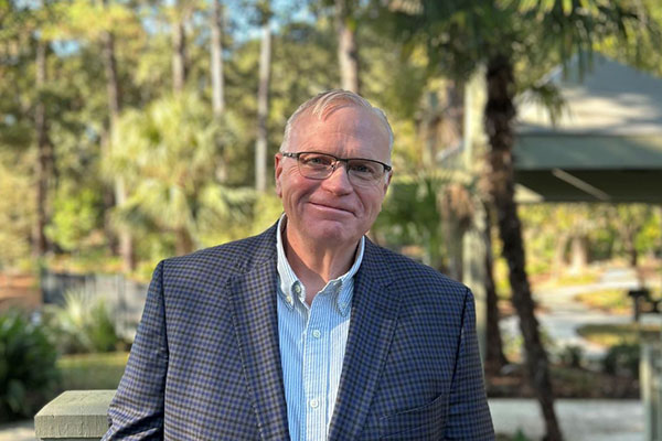 David Byrd outside with trees and path in background