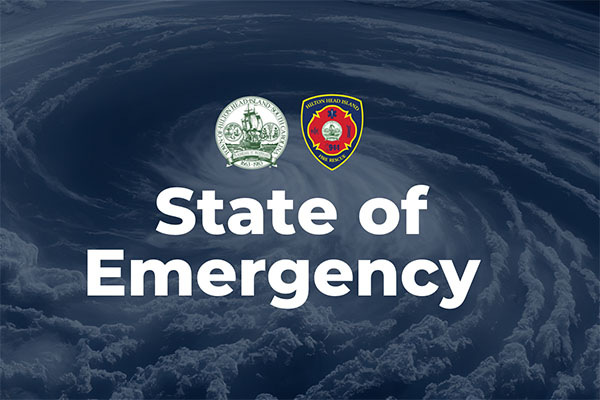 State of Emergency Text over faded hurricane image