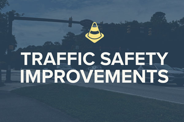 Traffic Safety Improvements text over a faded road intersection