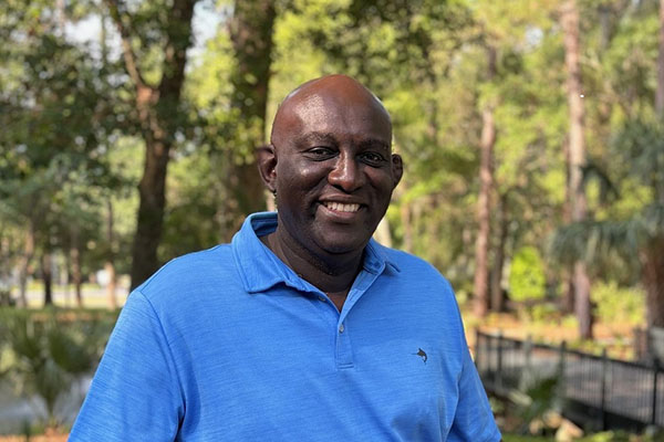 Derrick Coaxum outside Town Hall Xeriscape Garden