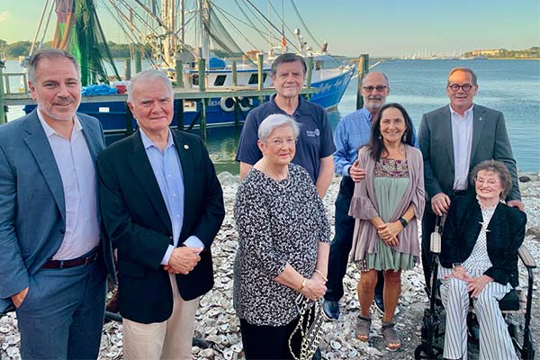Mayor McCann and Town Manager pictured with Honored Islander's in front of Shrimp Boat
